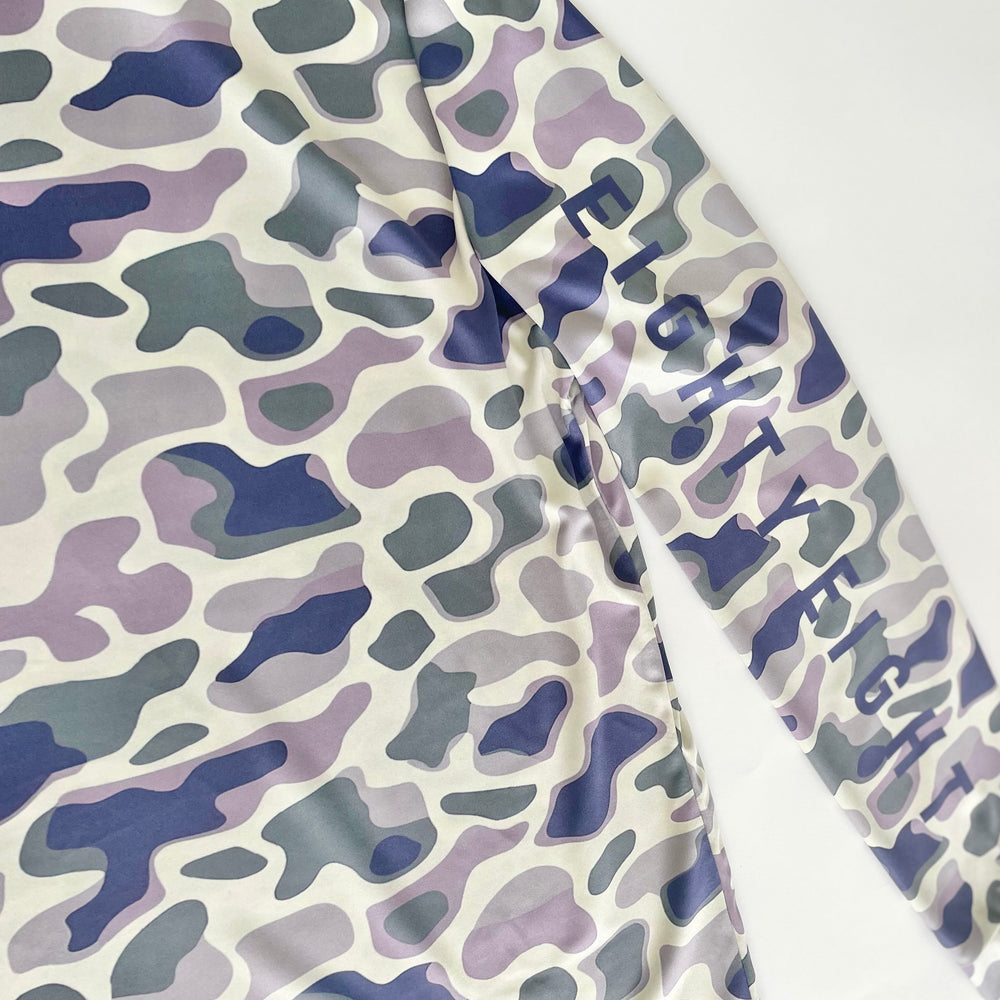 Camouflage-patterned fabric with 'Fifty Fifty' branding on a white background