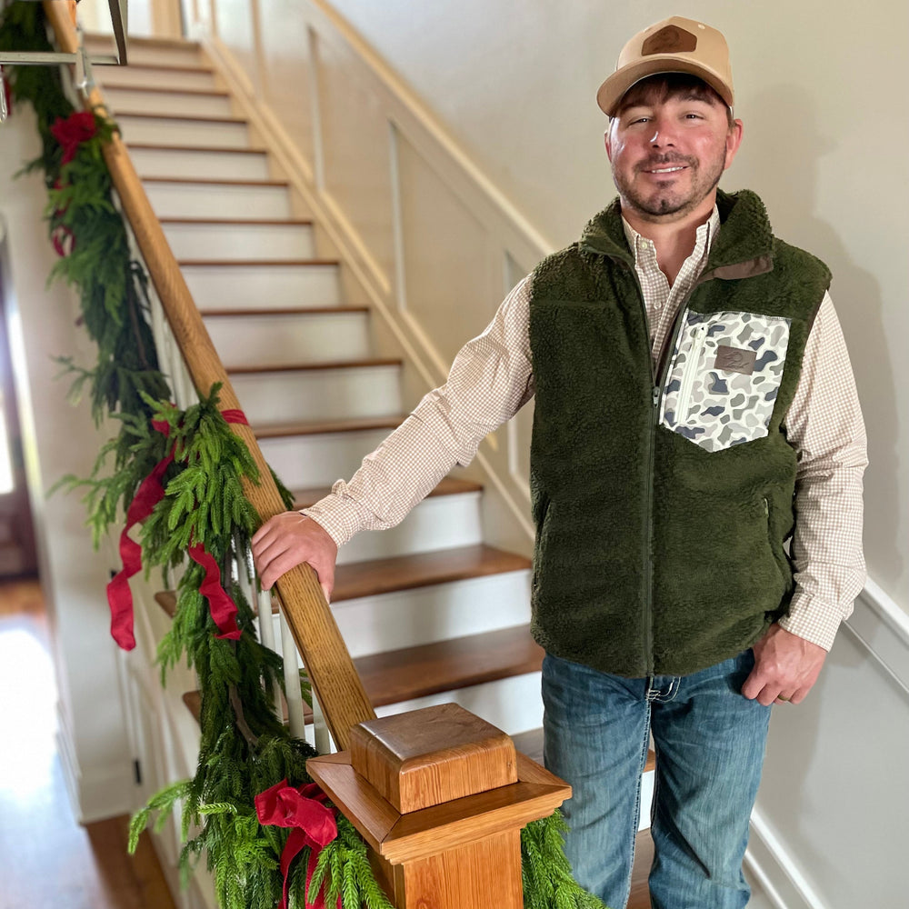 man in green fleece/sherpa vest with camo pocket