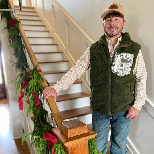 man in green fleece/sherpa vest with camo pocket