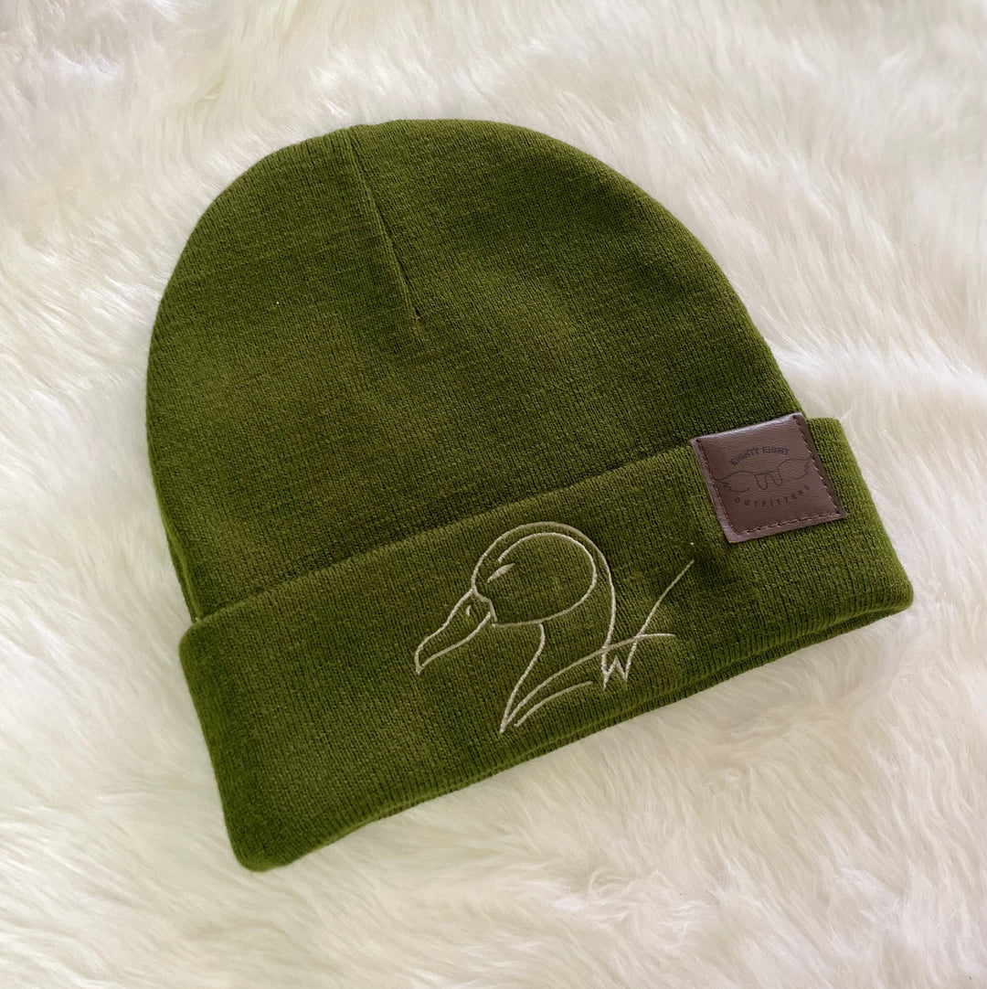 green fleece beanie with embroidery duck logo and leather logo tab on white background