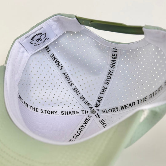 Green vcap with white mesh back on a light beige background