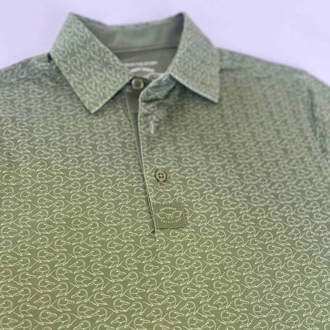 green youth polo with duck pattern on white background