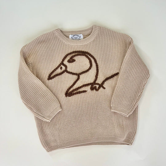 brown duck logo crocheted on khaki crochet sweater on white background