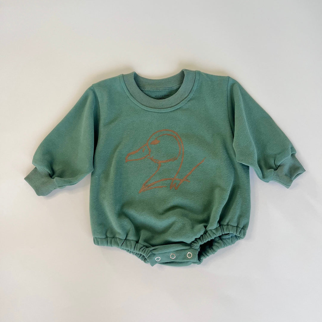 green long sleeve infant onesie with duck logo on white background