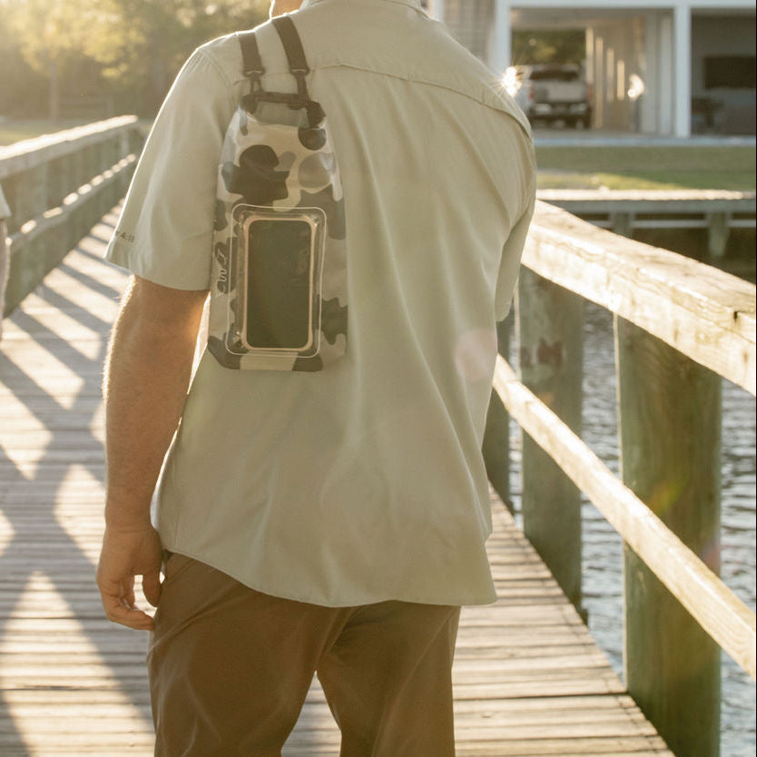 dry bag on shoulder with phone in waterproof compartment 
