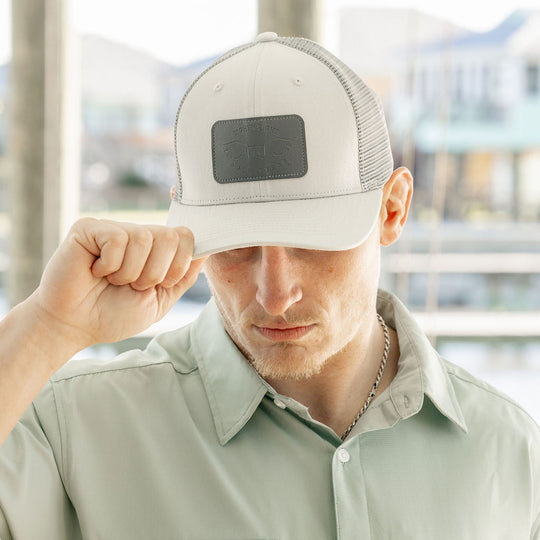 man wearing grey hat with leather patch