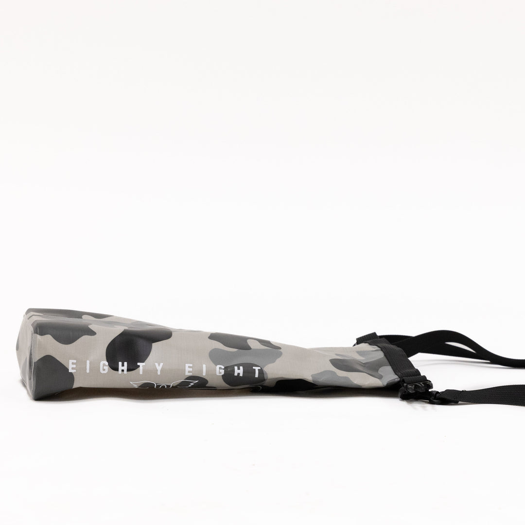 Camouflage-patterned product with a black strap on a white background